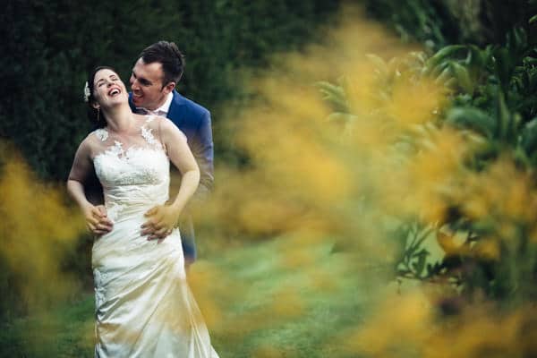 DIY Wedding Photography Northamptonshire Wedding Photographers capturing a romantic moment of a bride and groom kissing in a stunning garden in Northamptonshire.