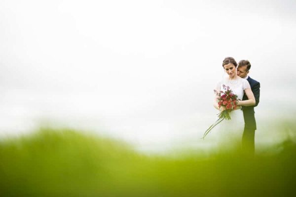 Beaitiful Wedding Photography-4 Wedding Photographers capturing a bride and groom in a picturesque field of grass in Northamptonshire.
