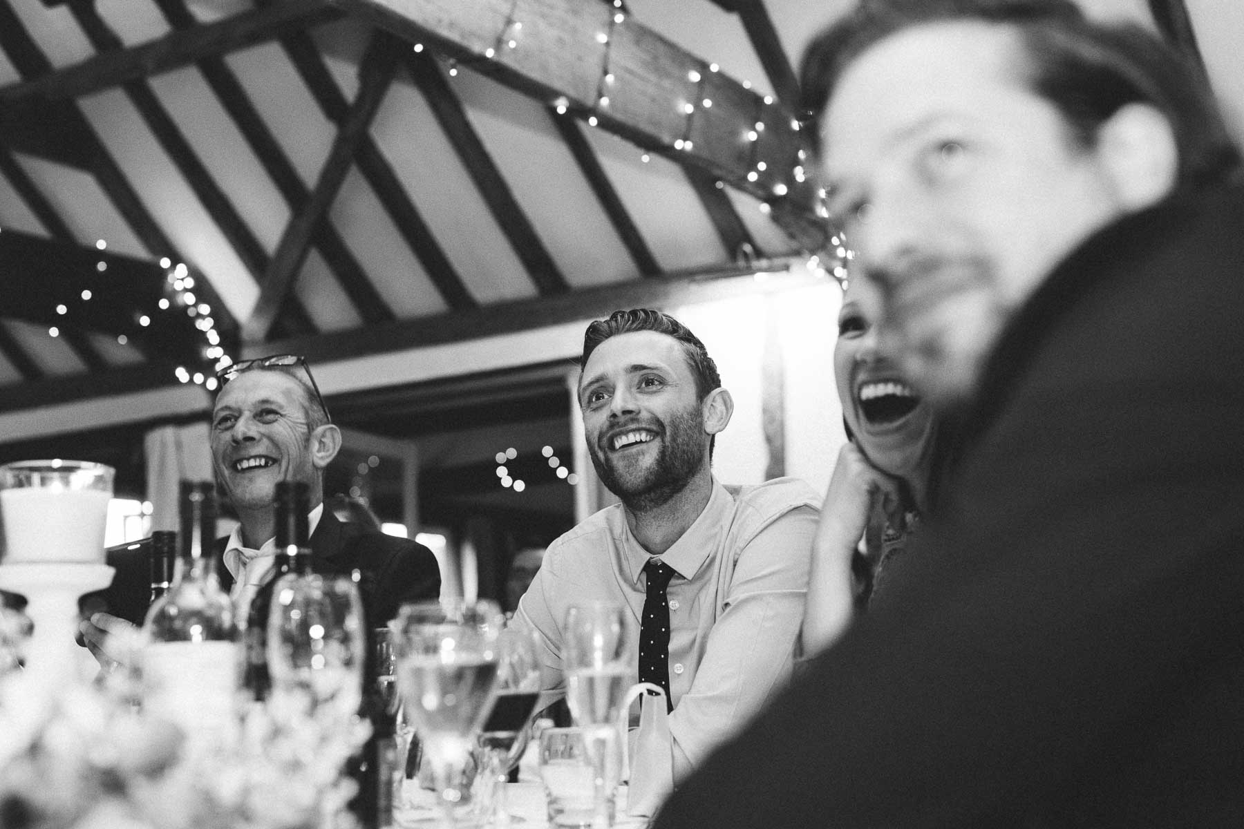 Wedding guests laughing at best man speech