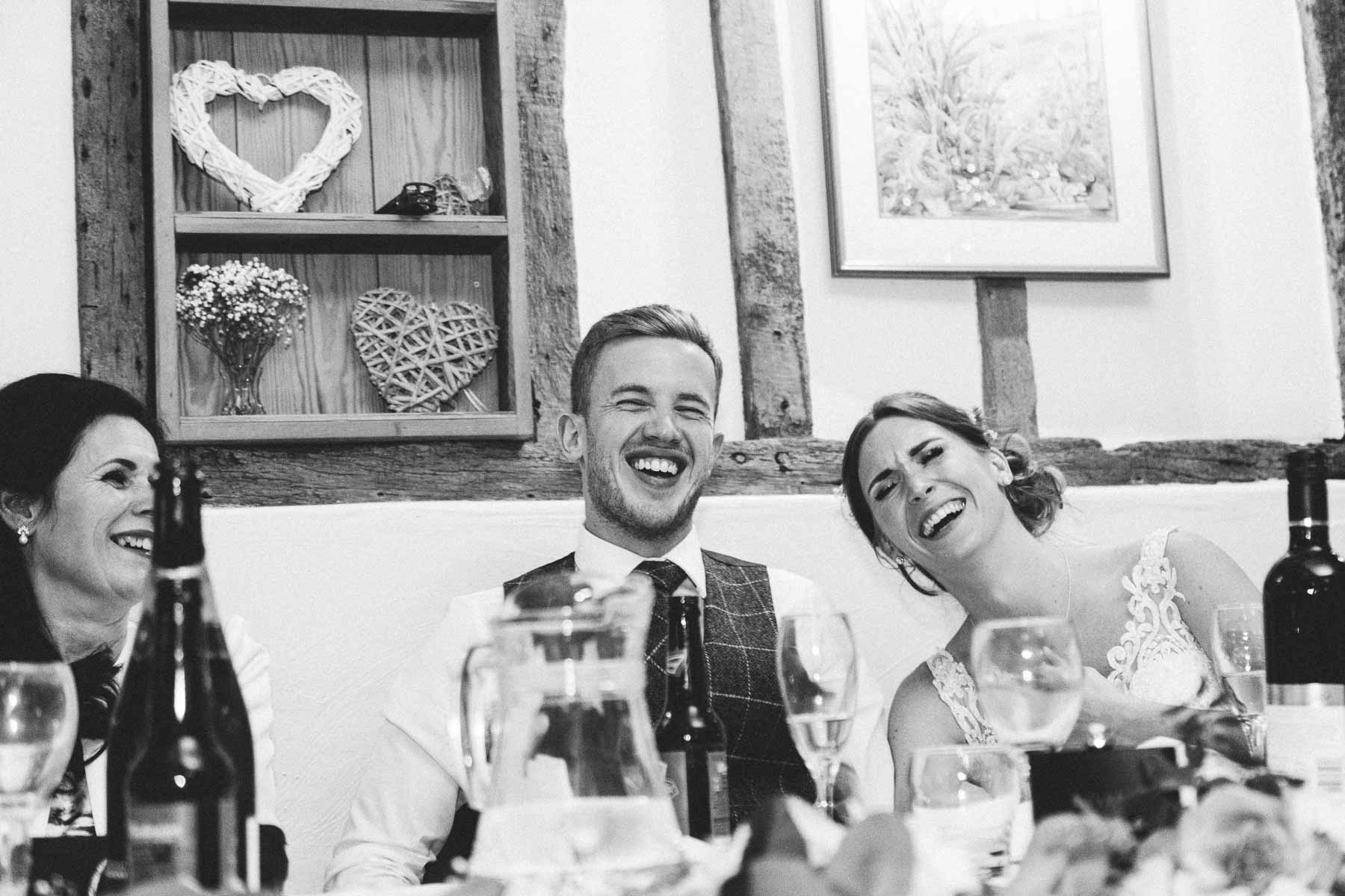 Bride and Groom laughing at speeches