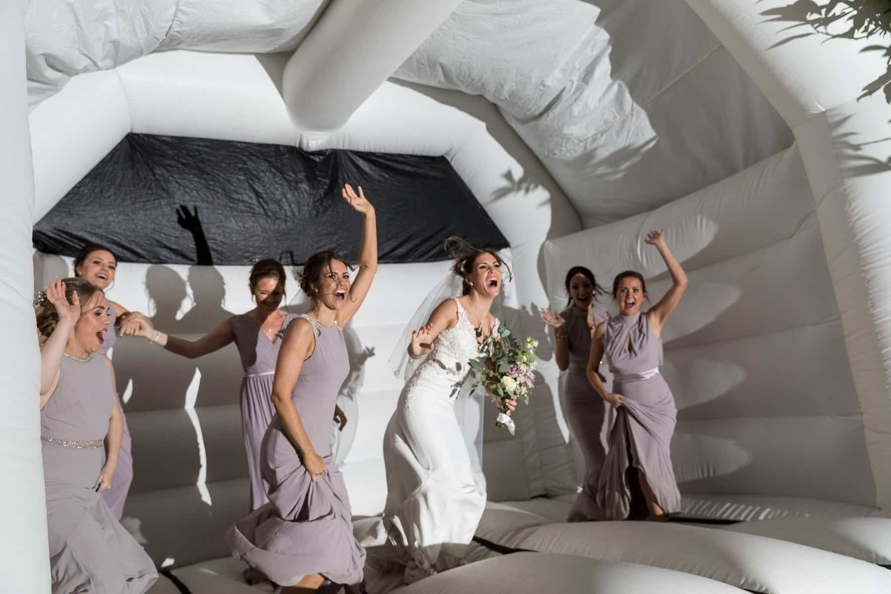 Bride Squad bouncing on a wedding bouncy castle