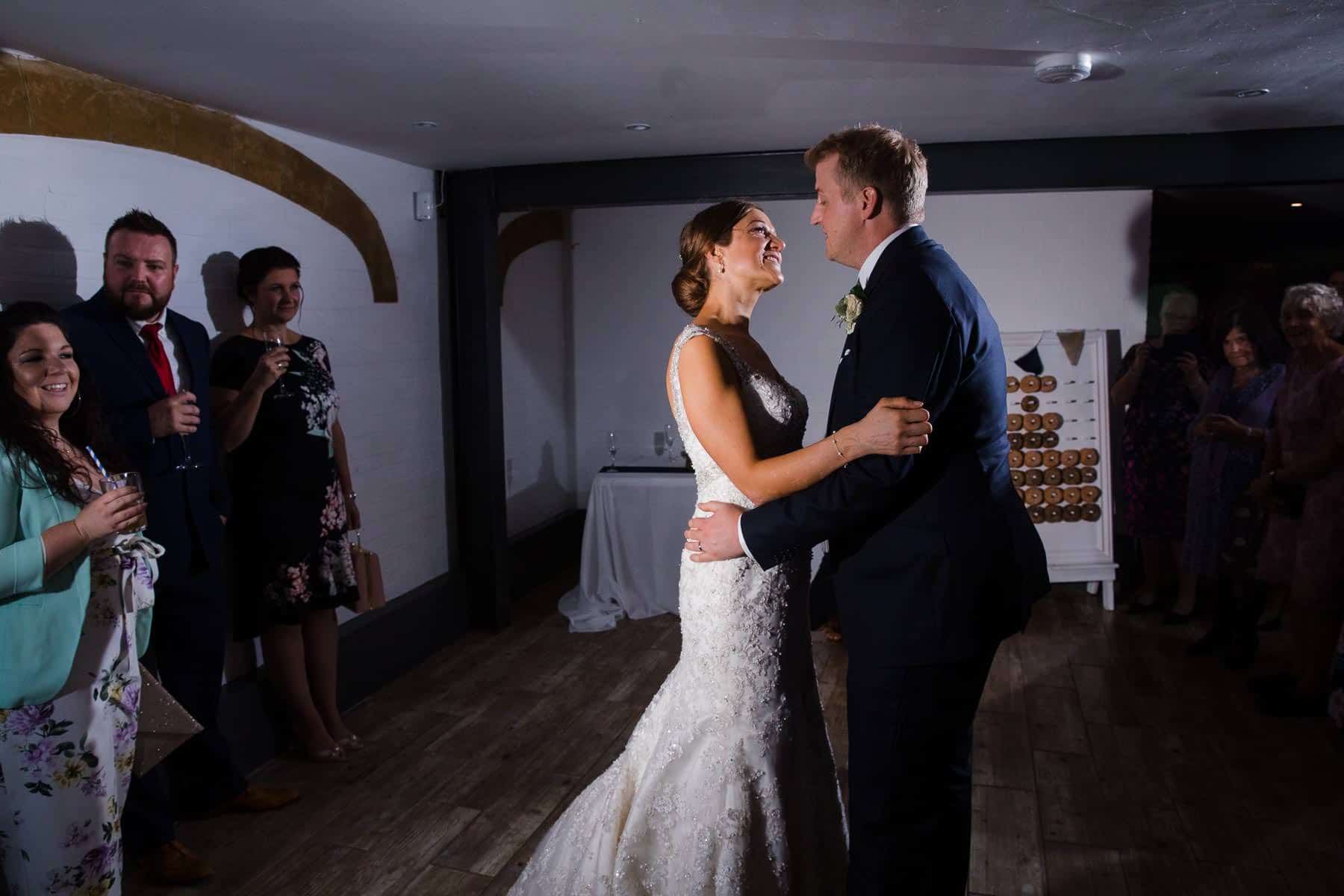 First Dance in a white room surrounded by friends and family