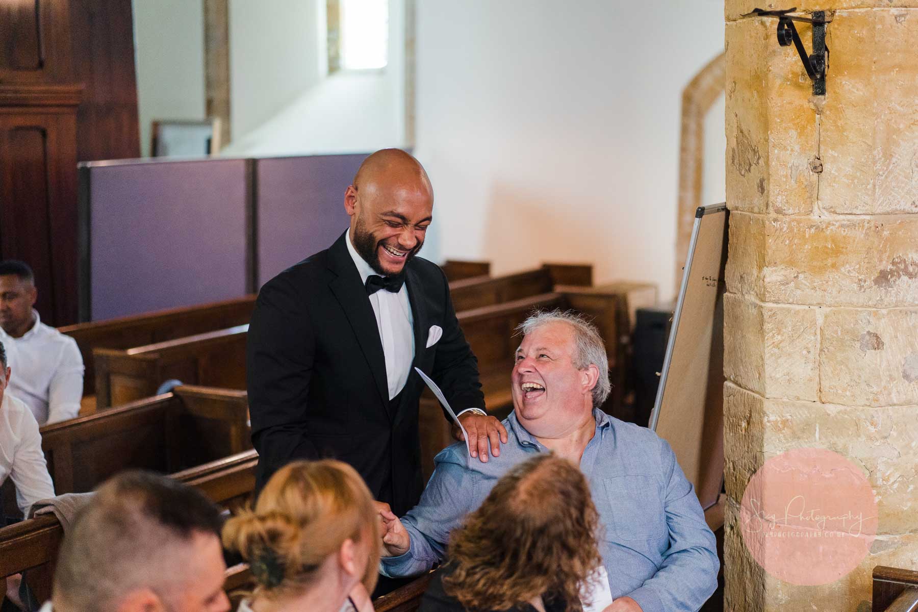 groom meeting guests at dodford church