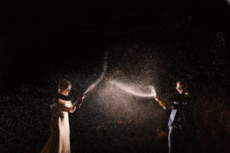 Natural Wedding Photography-6 A bride and groom blowing bubbles in the dark captured by expert Northampton wedding photographers specializing in sky photography.