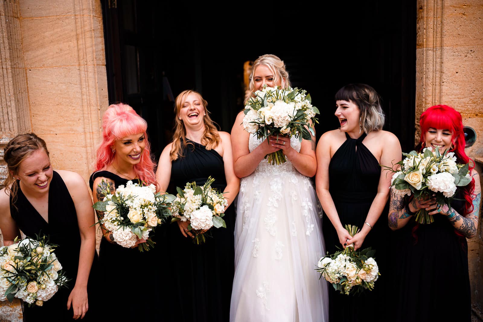 bridesmaids wearing elegant black dresses for photos at holdenby house