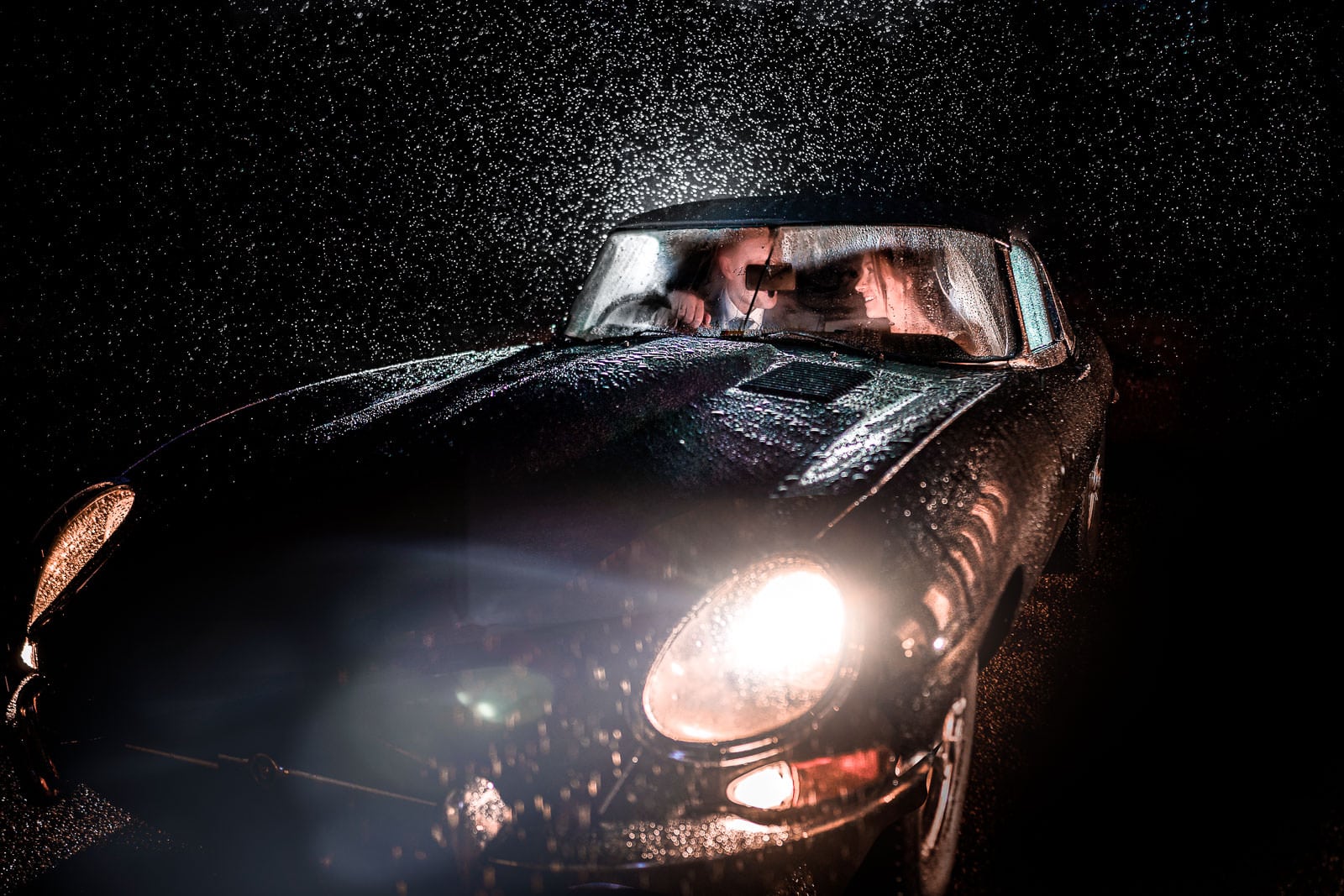 Rushton Hall Wedding Photographer winter photo of an e-type jag in the rain at night