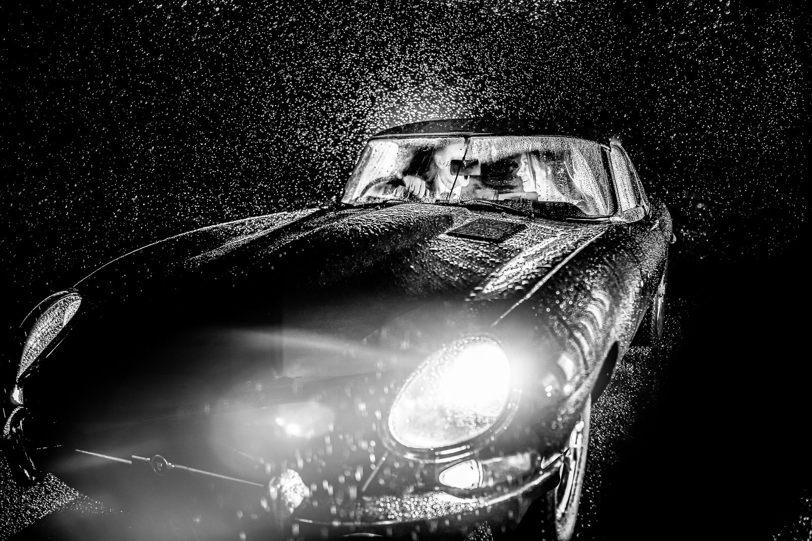 Rushton Hall Wedding Photographer winter photo of an e-type jag in the rain at night