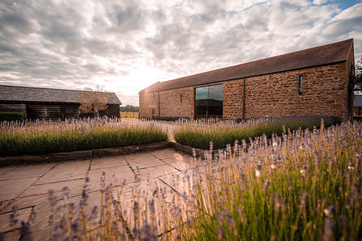 Dodford Manor Wedding Venue-2 Dodford Manor, a stone barn venue, nestled amidst expansive lavender fields, provides the perfect picturesque backdrop for captivating wedding photography.