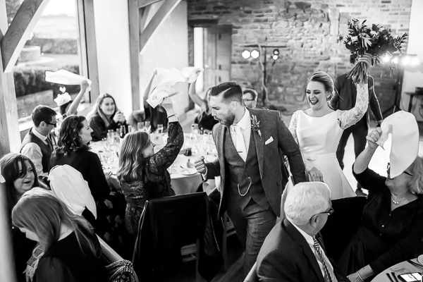 wedding photography portfolio 5 Bride and groom enter wedding reception with cheers.