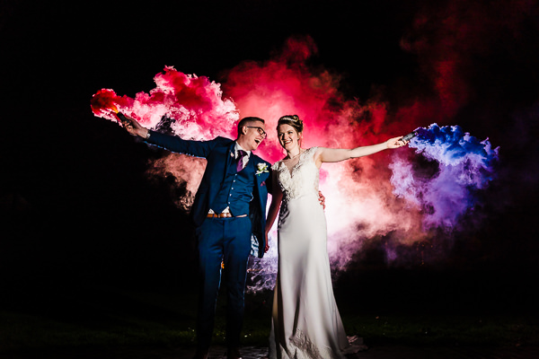 winter low light wedding photographer 11 Bride and groom with colourful smoke at night