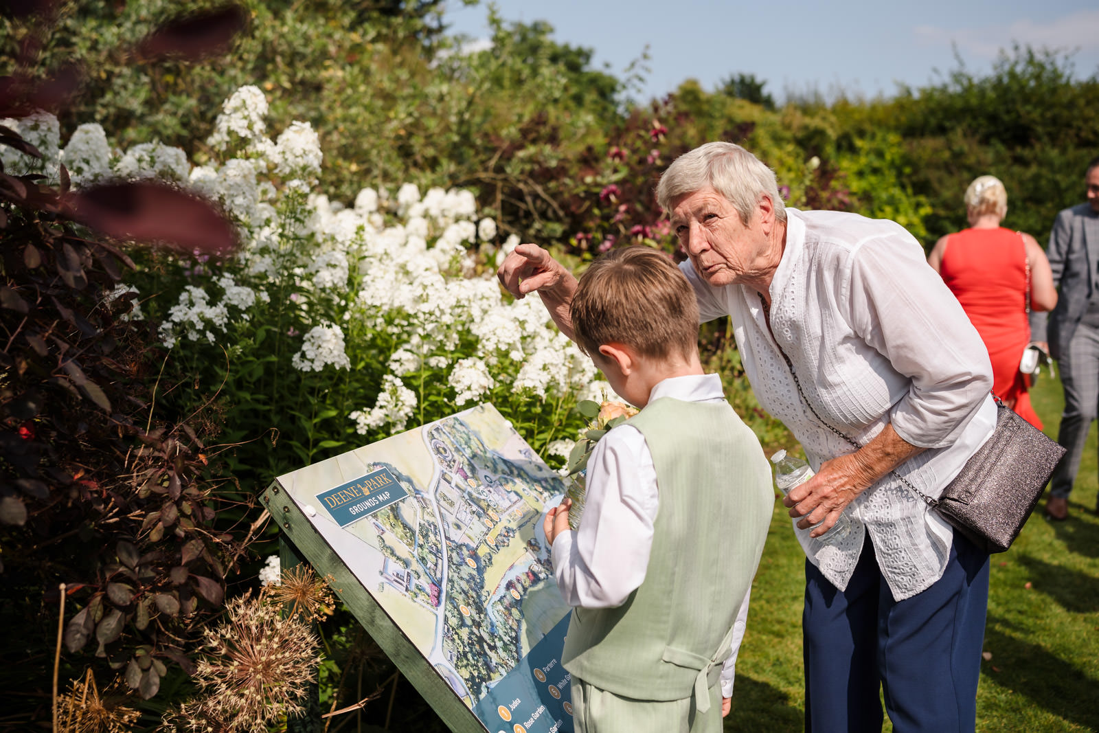 Woman and child examine garden map together.
